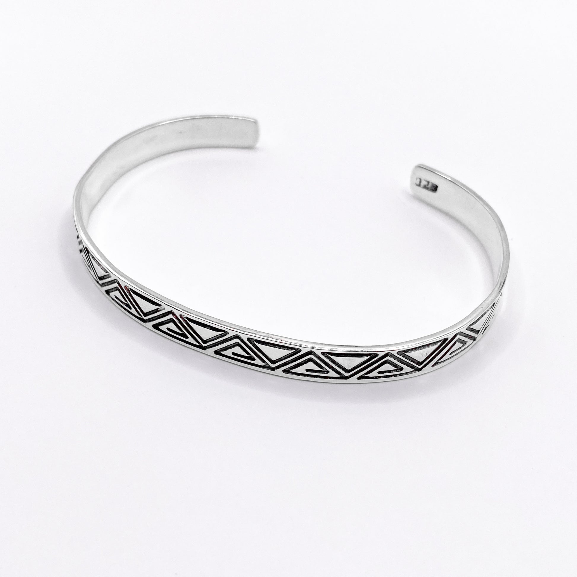 Bracelet en argent finement ciselé avec des motifs géométriques tribaux, produit artisanal de la boutique Altiplano. Le modèle "ZACUALLI" incarne le savoir-faire et l'élégance des bijoux latino-américains.