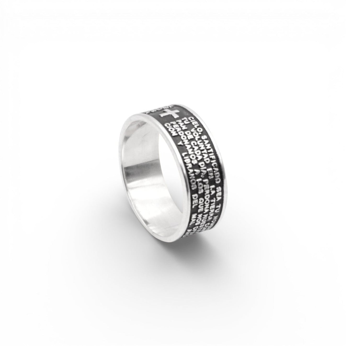 Une bague en argent avec une finition polie, ornée de gravures détaillées de textes et une petite croix en relief. Produit intitulé "PADRE", disponible chez Altiplano, une boutique en ligne spécialisée dans les bijoux latino-américains en argent.